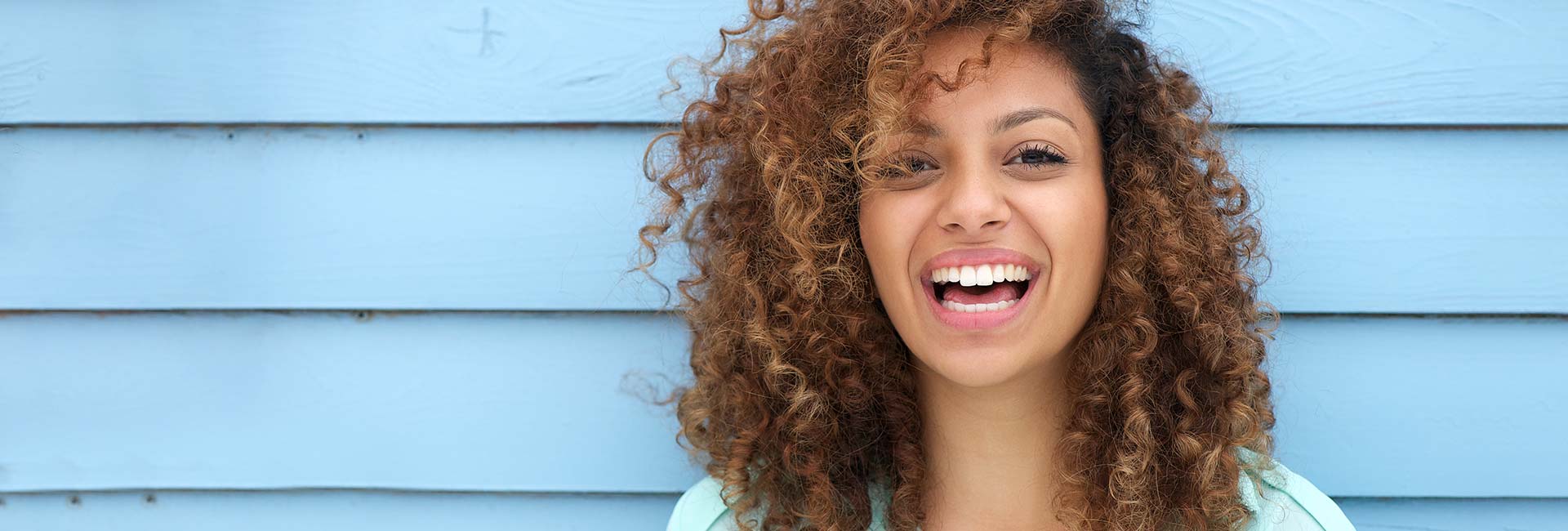 Afro American woman smiling with bright white teeth
